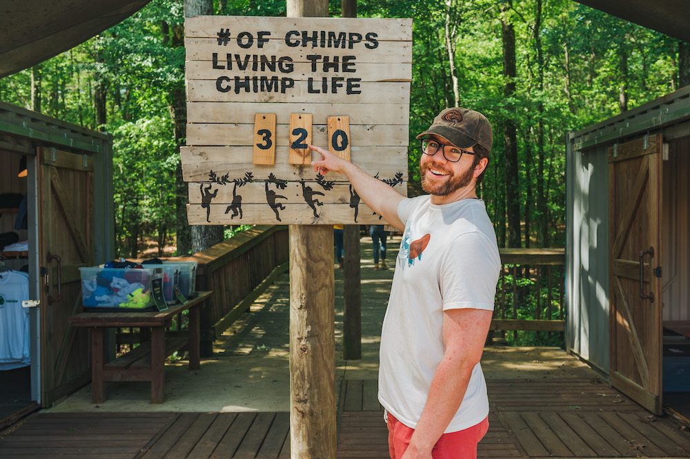 volunteer pointing at sign